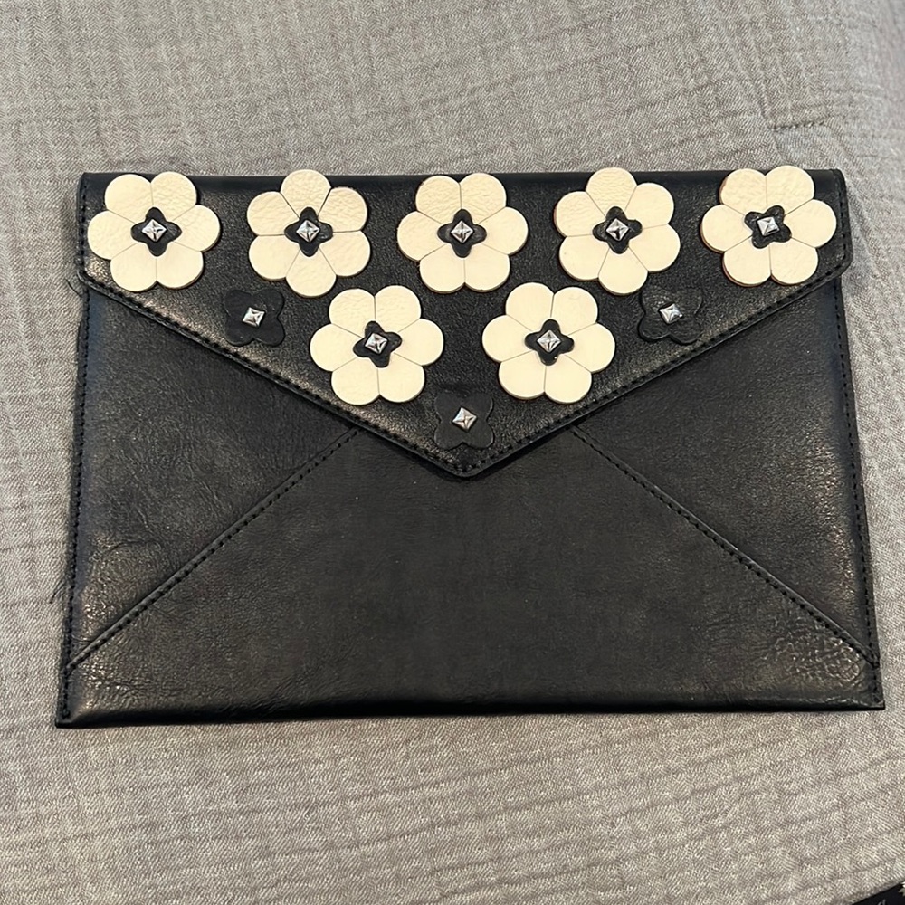 Black Rebecca Minkoff clutch with fun floral detailing! Like new. Only used once